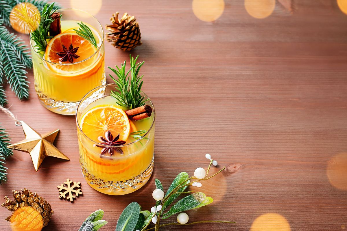 Bourbon cocktails on a table with greenery.